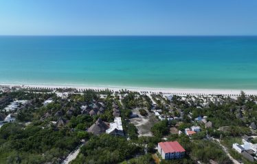 Holbox titled lots for sale — aerial drone view of Lotes Paraíso 150 m² near hotel zone and Caribbean beach